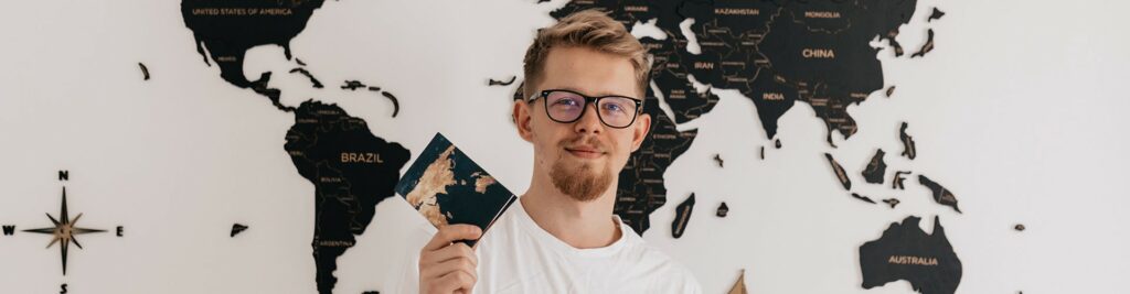 Guy With A Passport In Front Of The Map