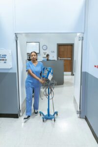 Nurse Pushing A Hospital Instrument