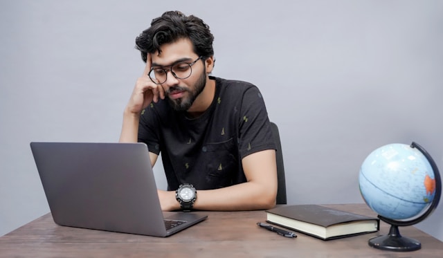 Man Looking At Computer For The Latest Australian Pr Points Change